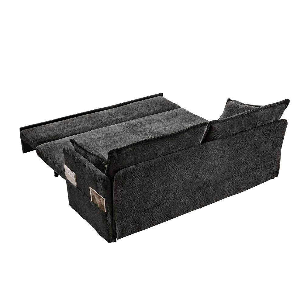 Side view of a black sleeper sofa extended into a bed.