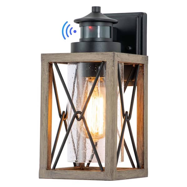 C Cattleya 1-Light Black and Faux Wood Motion Sensing Dusk to Dawn Outdoor Wall Lantern Sconce with Clear Seeded Glass