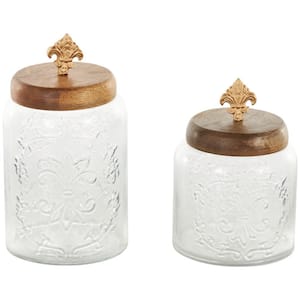 Clear Glass Scroll Decorative Jars with Brown Wooden Lids and Gold Fleur-De- Lis Knobs (Set of 2)