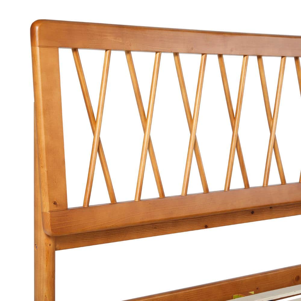 Close-up of the geometric X-pattern on a brown solid wood headboard.