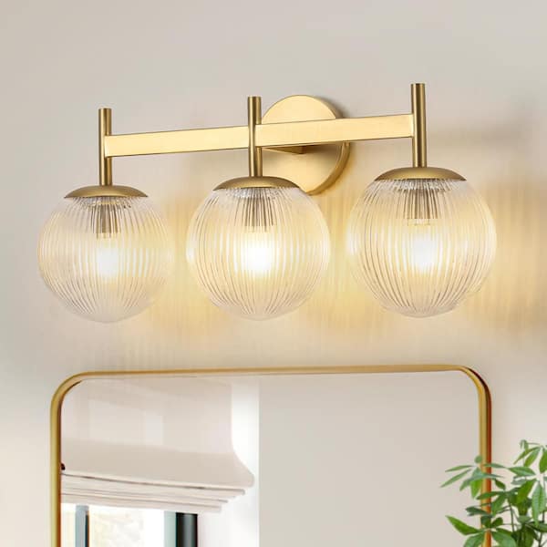 Noble 21.9 in. 3-Light Vintage Industrial Brushed Gold Bathroom Vanity Light with Round Clear Globe Ribbed Glass Shade