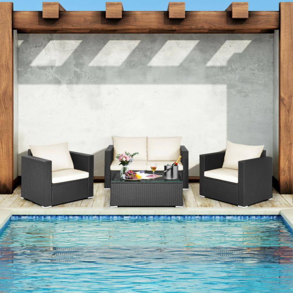 Outdoor conversation set on a patio by a pool.