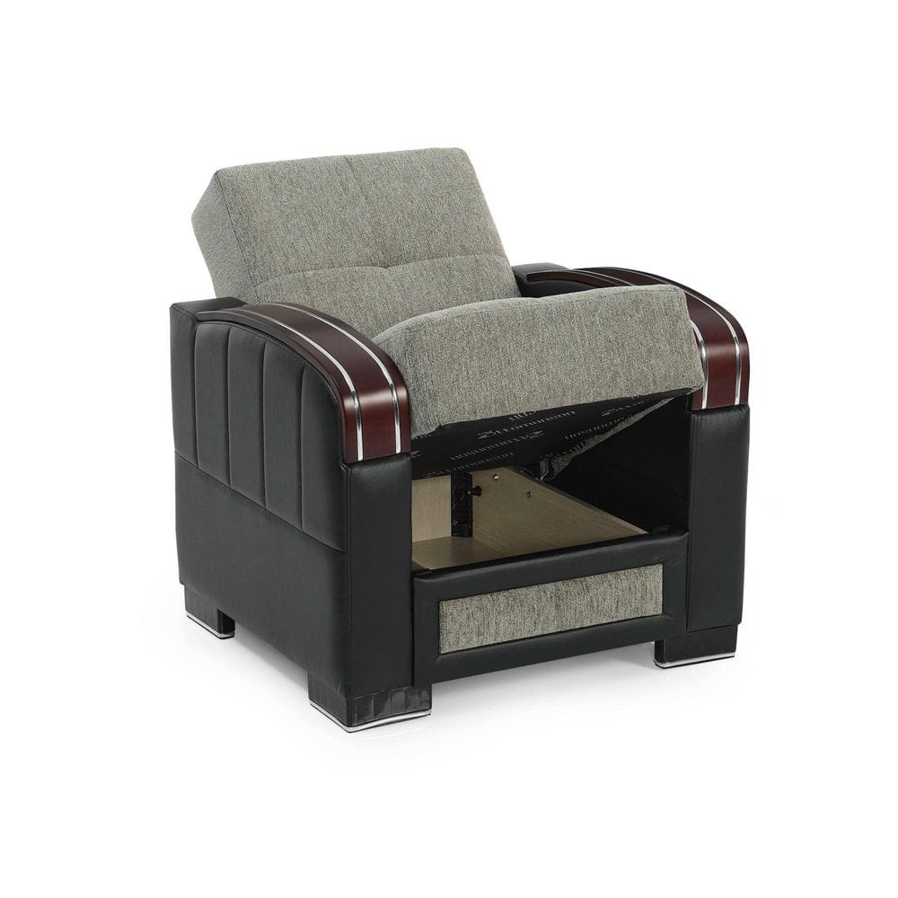 Black armchair with grey cushions and storage in a studio shot.