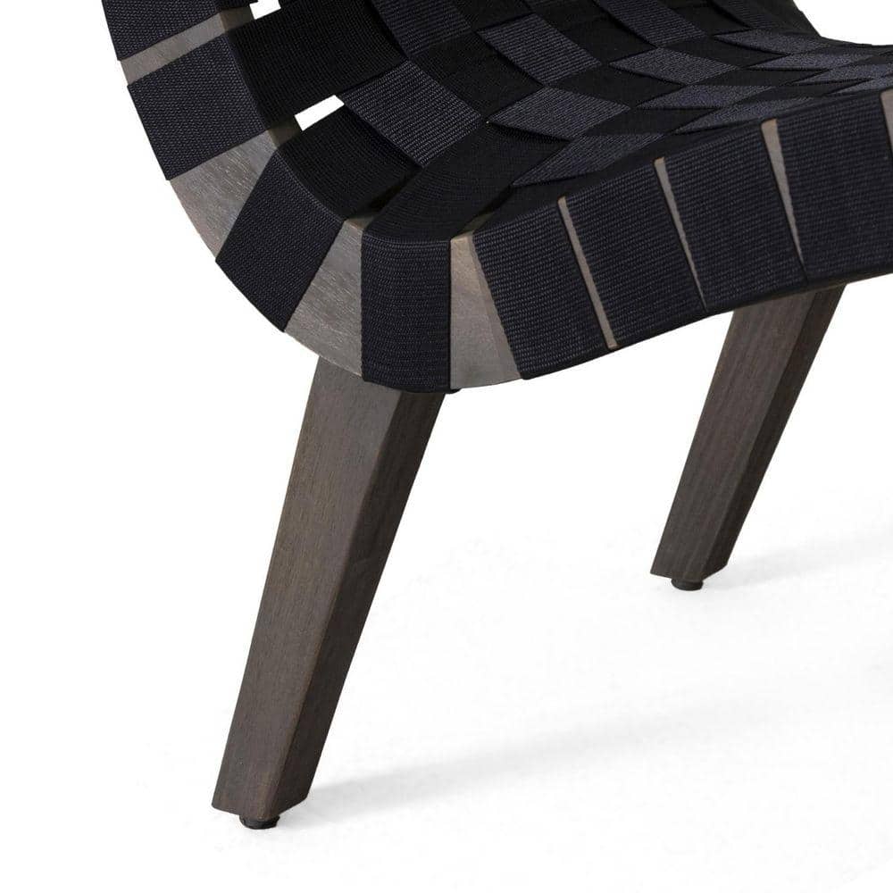 Close-up of the corner and seat of a black woven lounge chair.