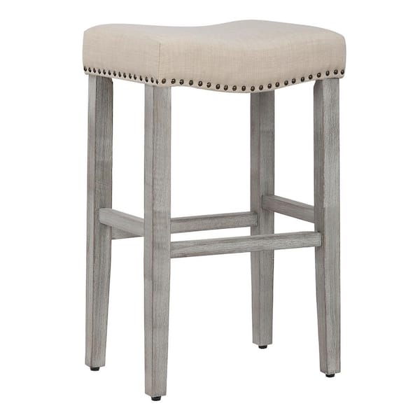 WESTINFURNITURE Jameson 29 in. Bar Height Antique Gray Wood Backless Nailhead Trim Barstool with Upholstered Beige Linen Saddle Seat