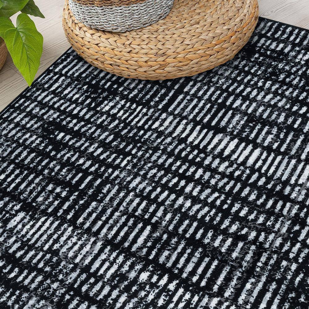 Black and Ivory Geometric Polypropylene Area Rug 2' x 7'