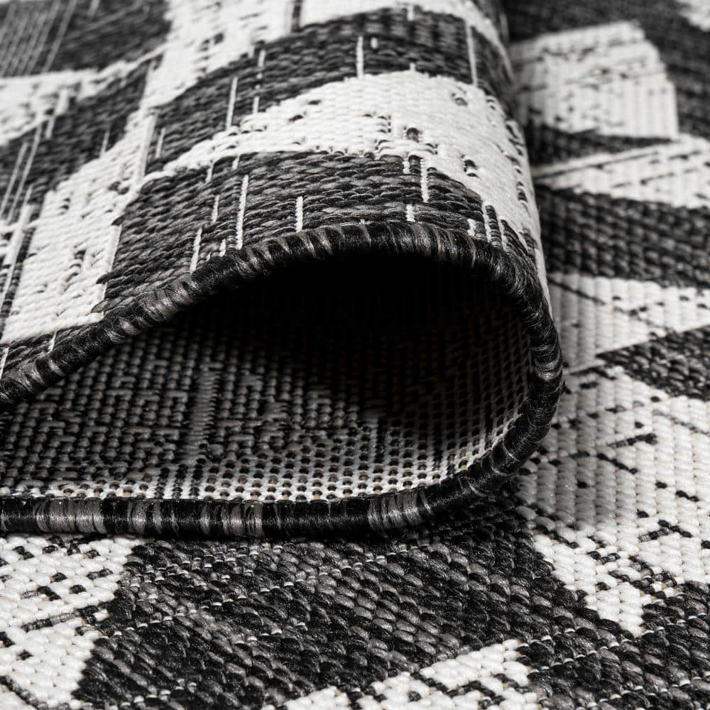 5' x 8' Black and Ivory Geometric Synthetic Area Rug