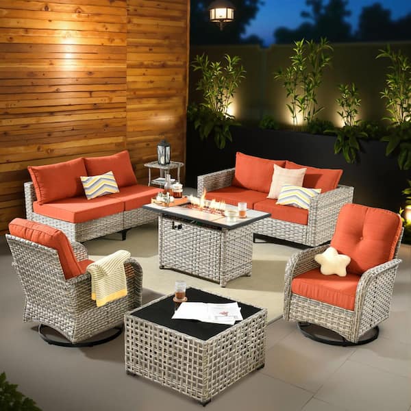XIZZI Enchanted 9 Pieces Wicker Outdoor Patio Rectangular Fire Pit Set and Swivel Rocking Chairs with Orange Red Cushions