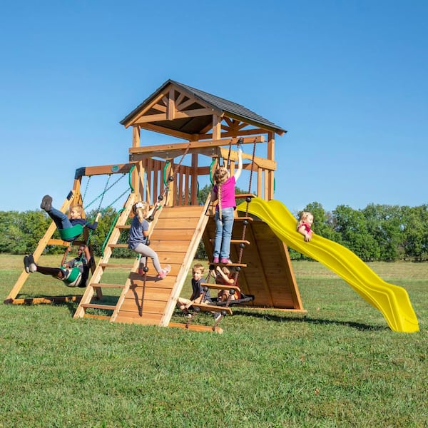 Backyard Discovery Endeavor Outdoor Playground Set w/ Elevated Clubhouse, Climbing Wall, Swing Set, Web Swing, and Yellow Wave Slide