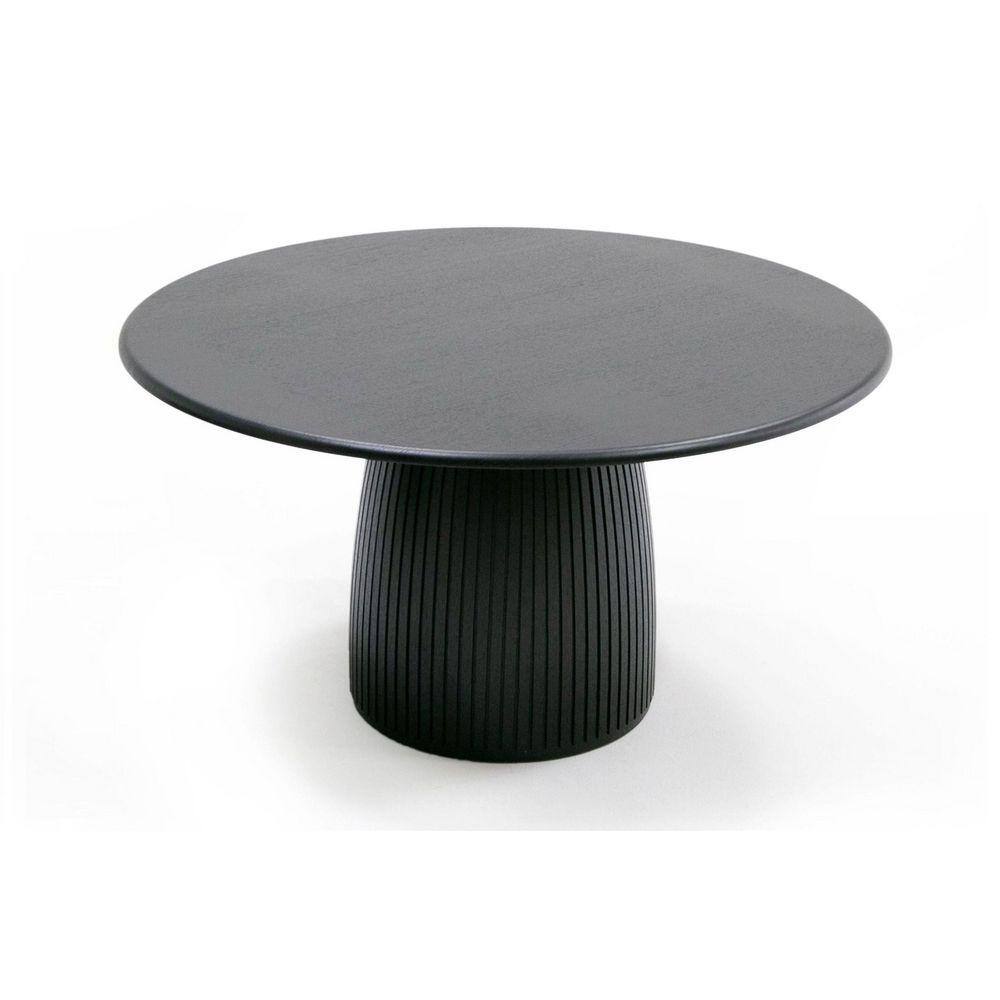 Black round pedestal dining table with a fluted base.