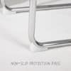 Close-up of the chrome metal frame and non-slip protection pads on the chair.