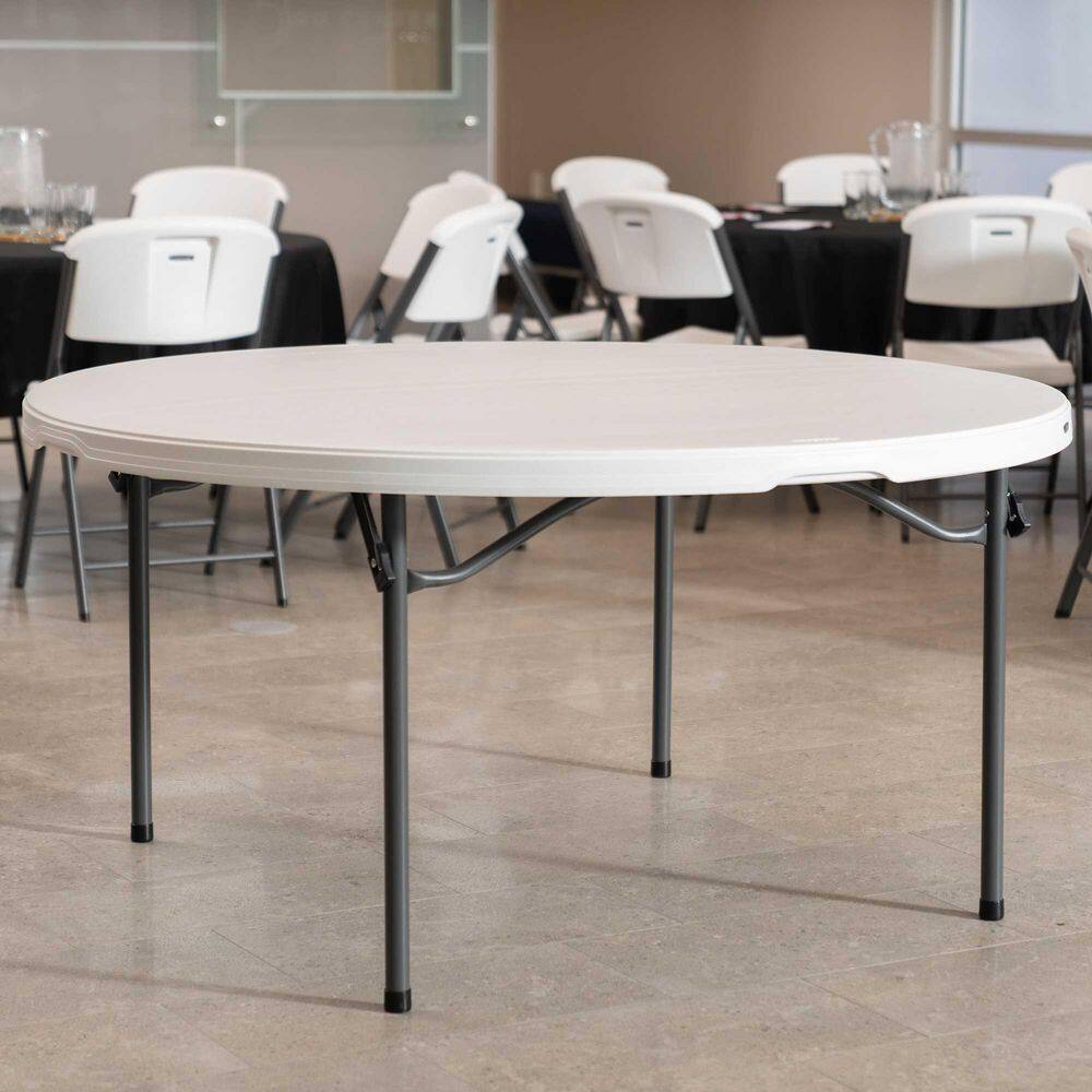 White folding tables set up in a formal dining setting.