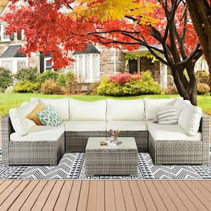 Long Outdoor 7-Piece Gray Wicker/Rattan Sectional Seating Group with Beige Cushions