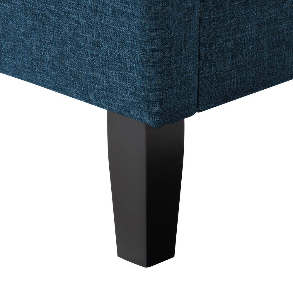 Close-up of the ocean blue fabric and dark brown leg of the bed.