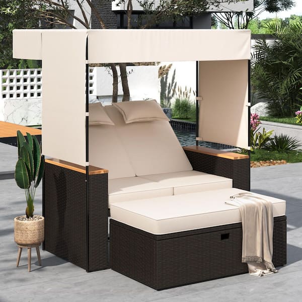 Brown Wicker Outdoor Day Bed with Beige Cushions and Pillows