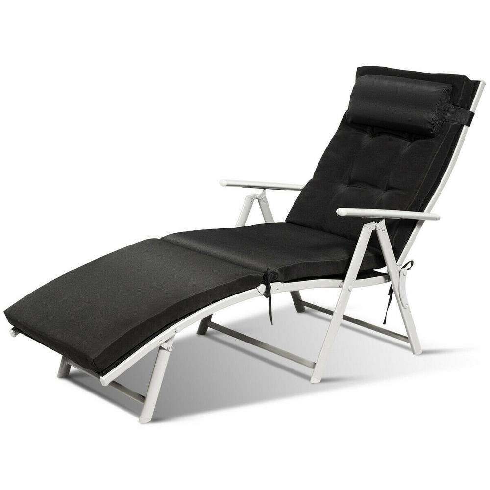 Black metal folding outdoor chaise lounge chair with cushion and pillow.