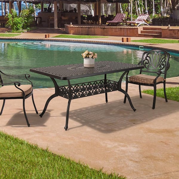 brown outdoor dining table with umbrella hole