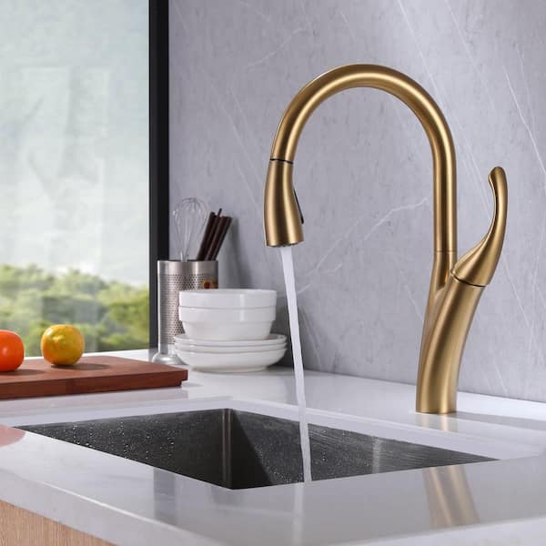 Utensils And Ornaments On Shelf Above Kitchen Sink With Golden Tap