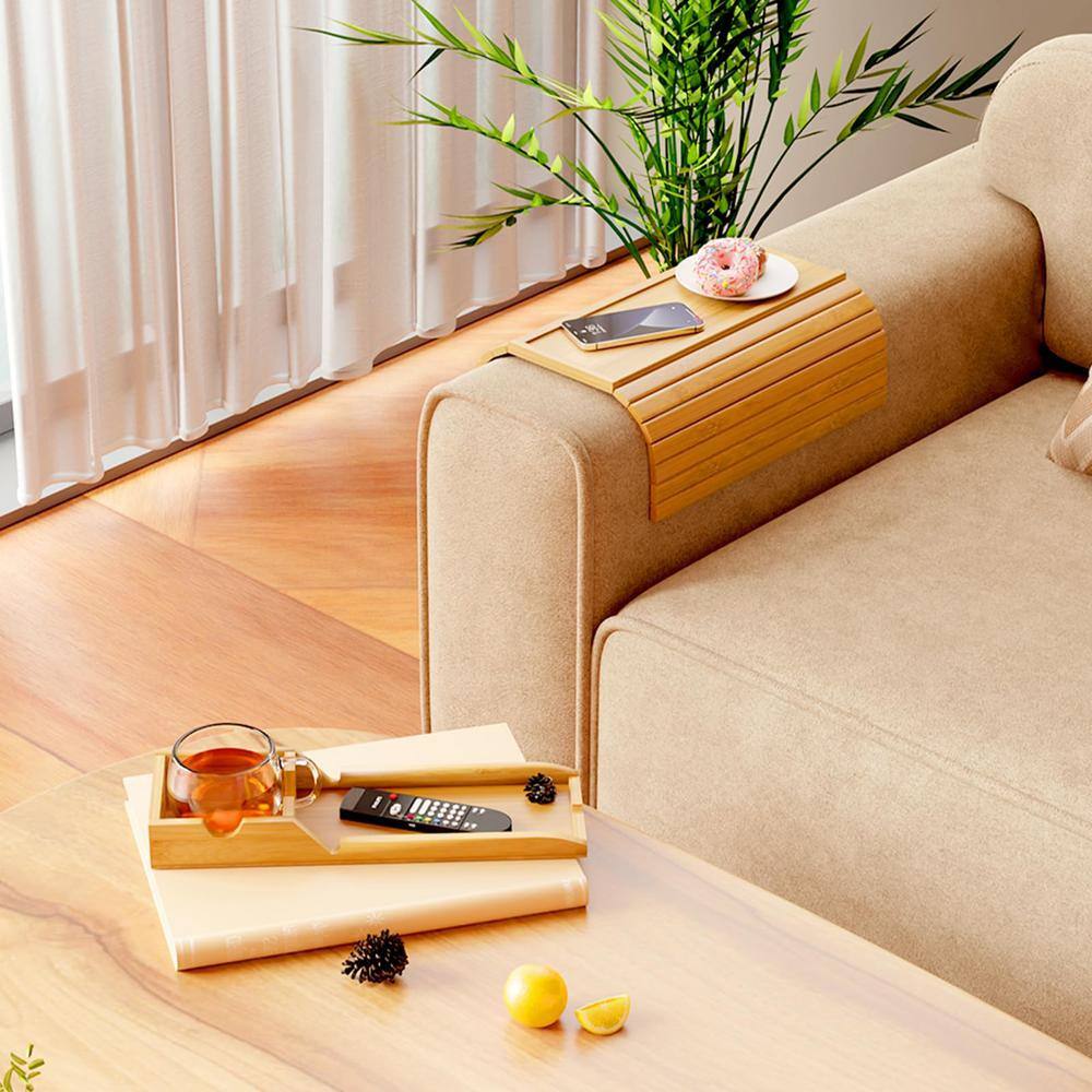 Bamboo tray holding a phone and drink on a table.