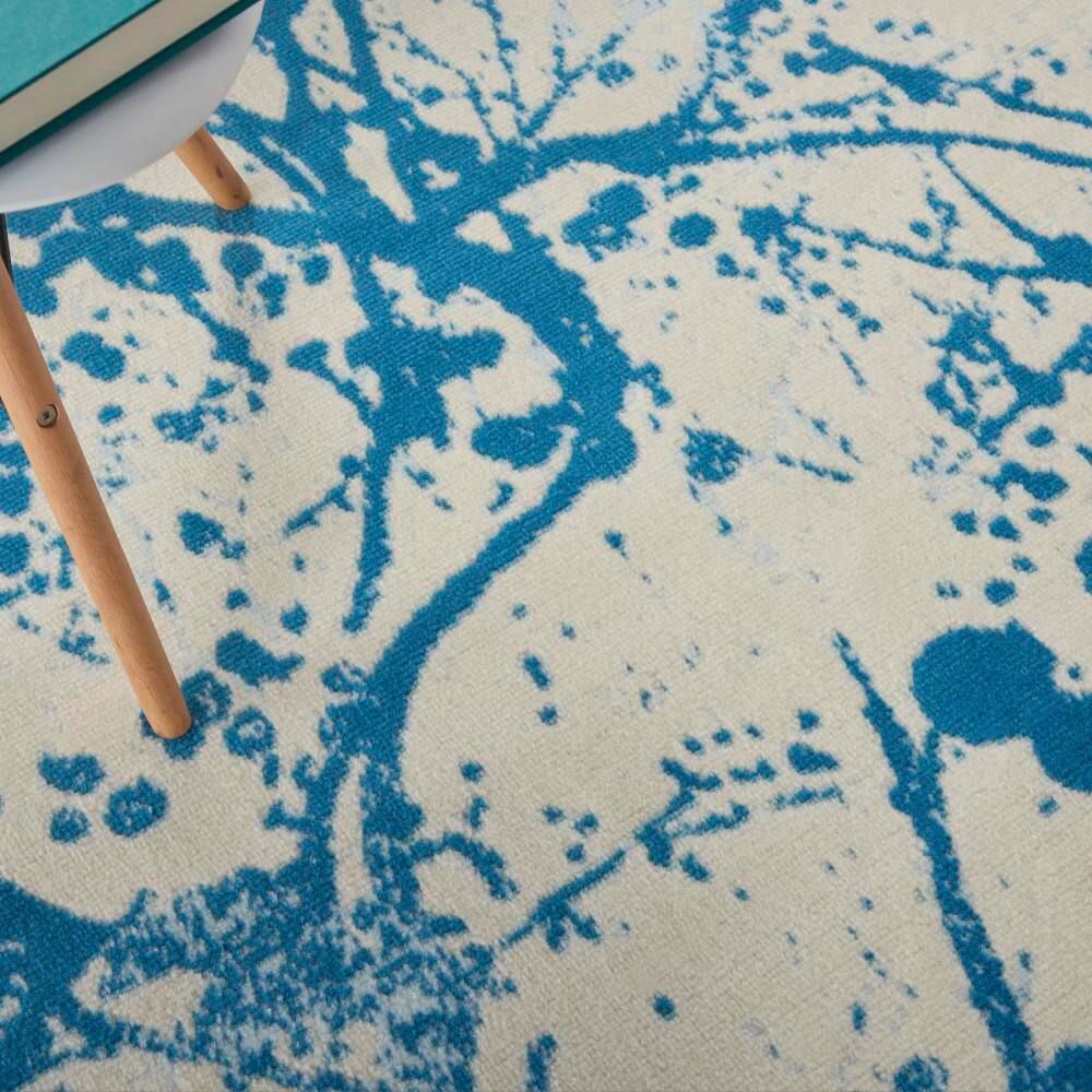 Ivory and Blue Abstract Synthetic 4' x 6' Easy-Care Area Rug