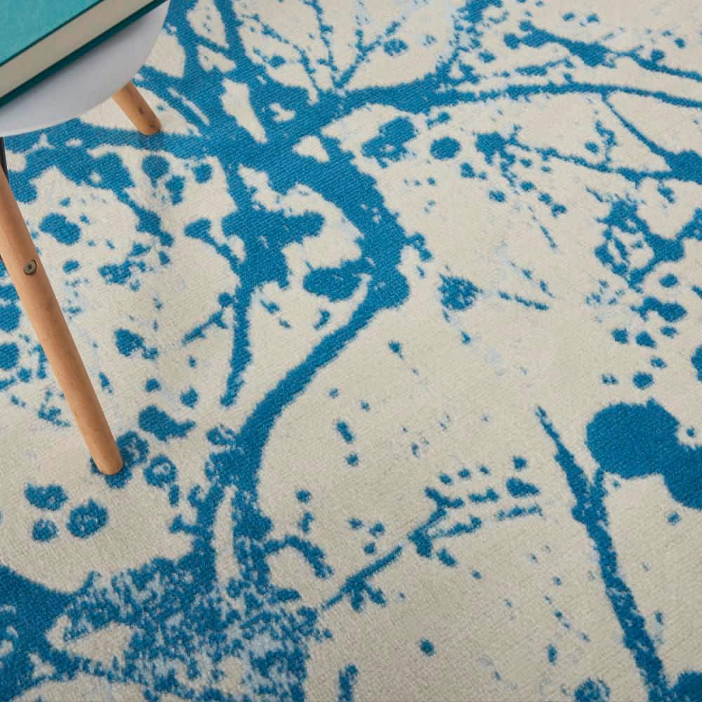 Ivory and Blue Abstract Synthetic 4' x 6' Easy-Care Area Rug