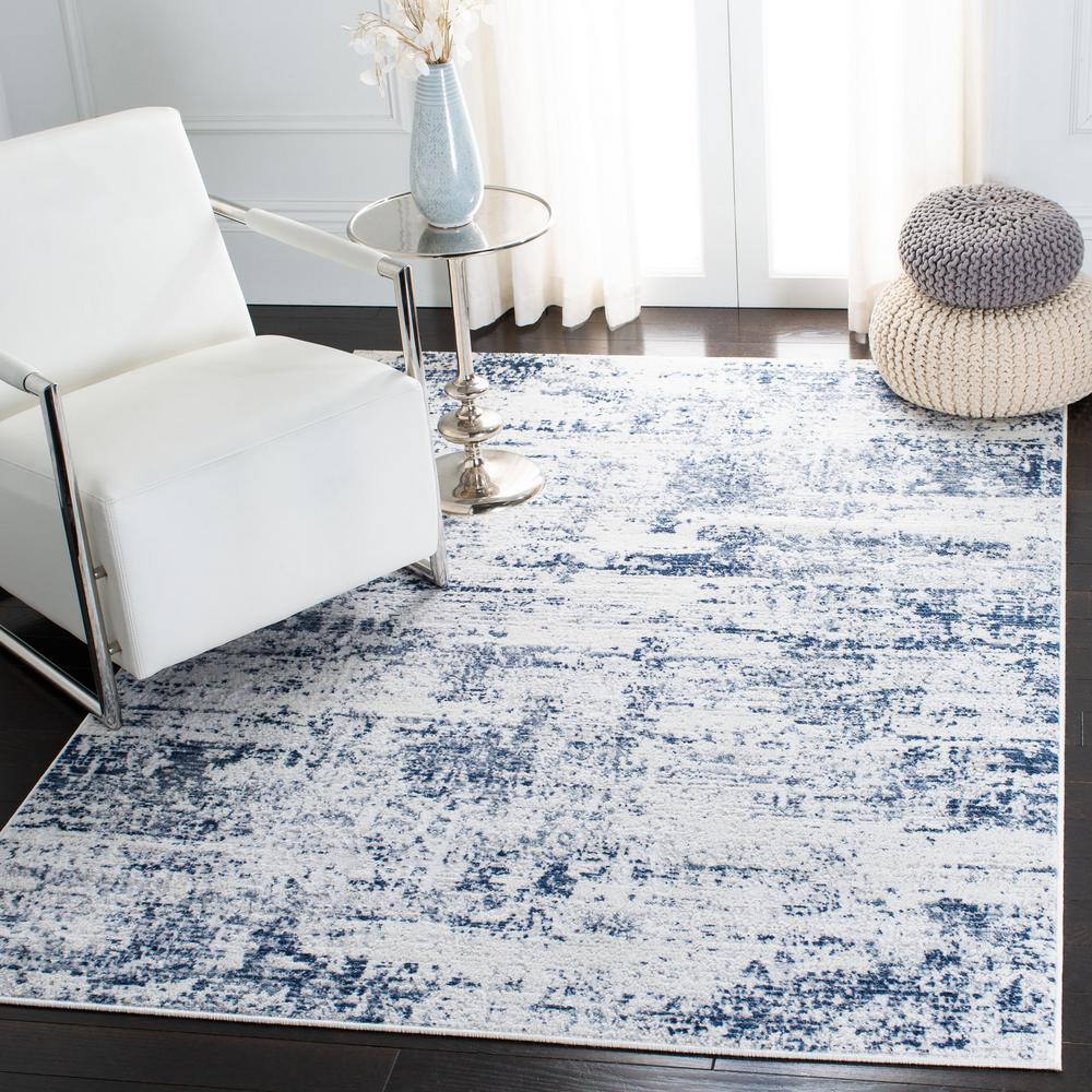 Ivory and Navy Abstract 8' x 10' Synthetic Area Rug
