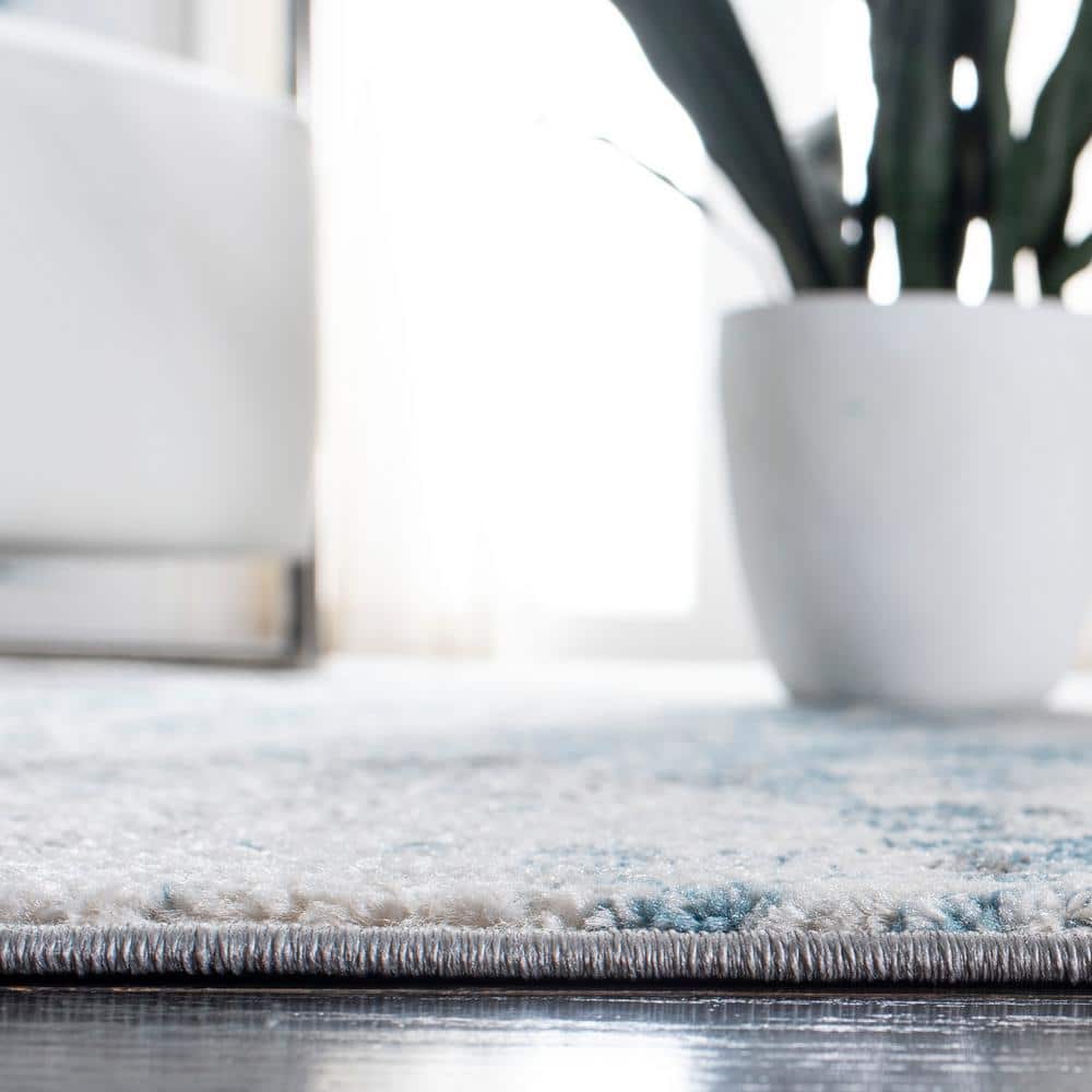 Ivory and Blue Abstract 9' x 12' Synthetic Area Rug