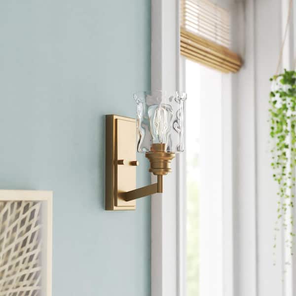 Designers Fountain Drake 5 in. 1-Light Brushed Gold Retro Wall Sconce with Clear Hammered Glass Shade