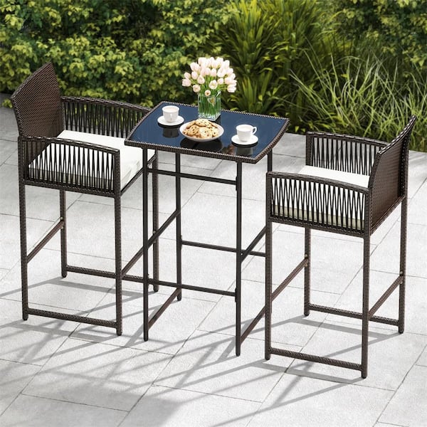 3 Piece Patio Bar Set Wicker Table and Armchairs with 2 Off White Cushions and Glass Tabletop