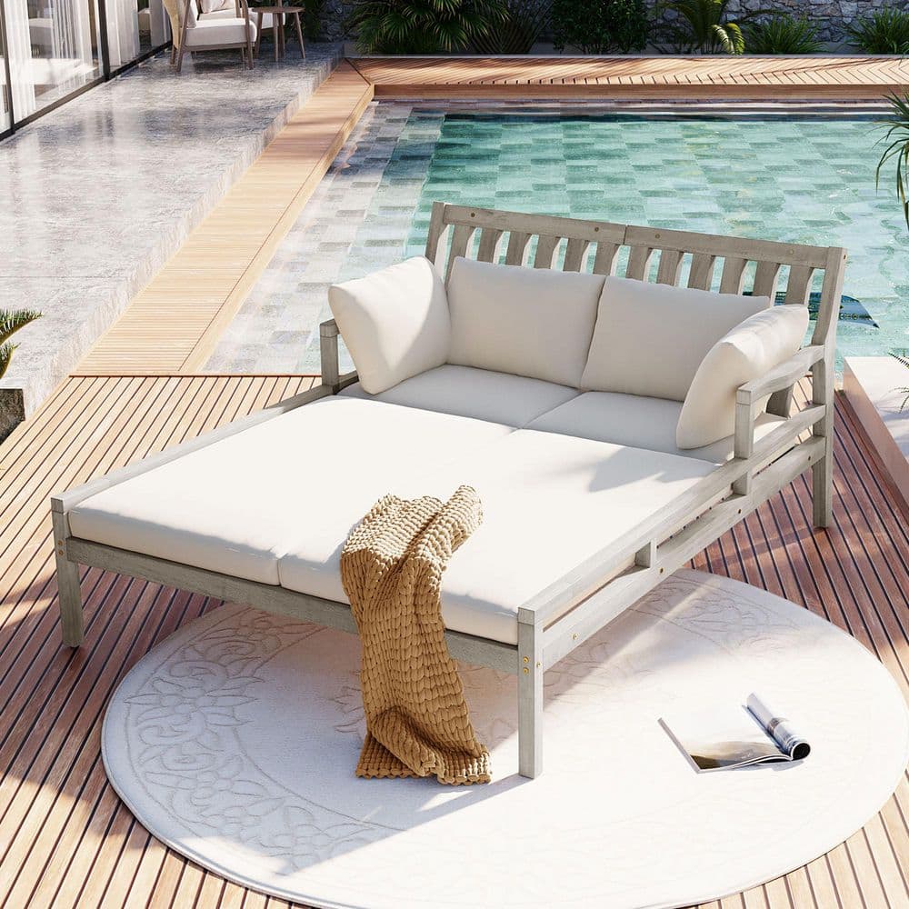 Gray Wood Outdoor Day Bed with Beige Cushions and Curved Armrests
