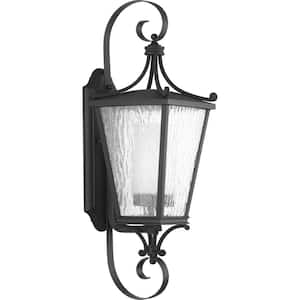 Cadence Collection 1-Light Textured Black Clear Water Seeded Glass Luxe Outdoor Medium Wall Lantern Light