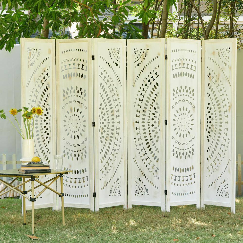 White-washed carved room divider used as an outdoor privacy screen.