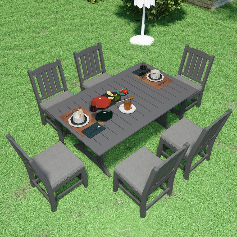 A 7-piece dark gray outdoor dining set on a lawn.