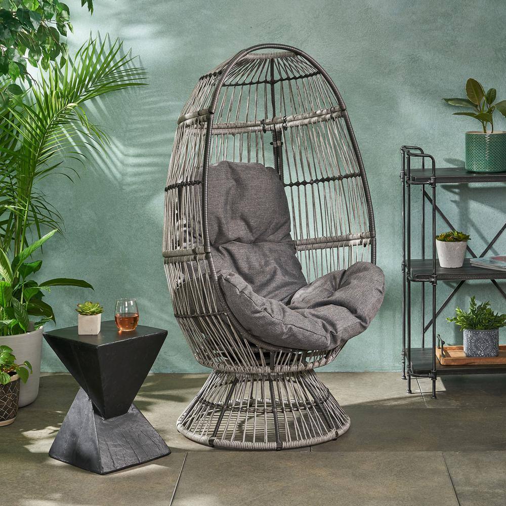 Outdoor lounge chair in a garden setting with plants.