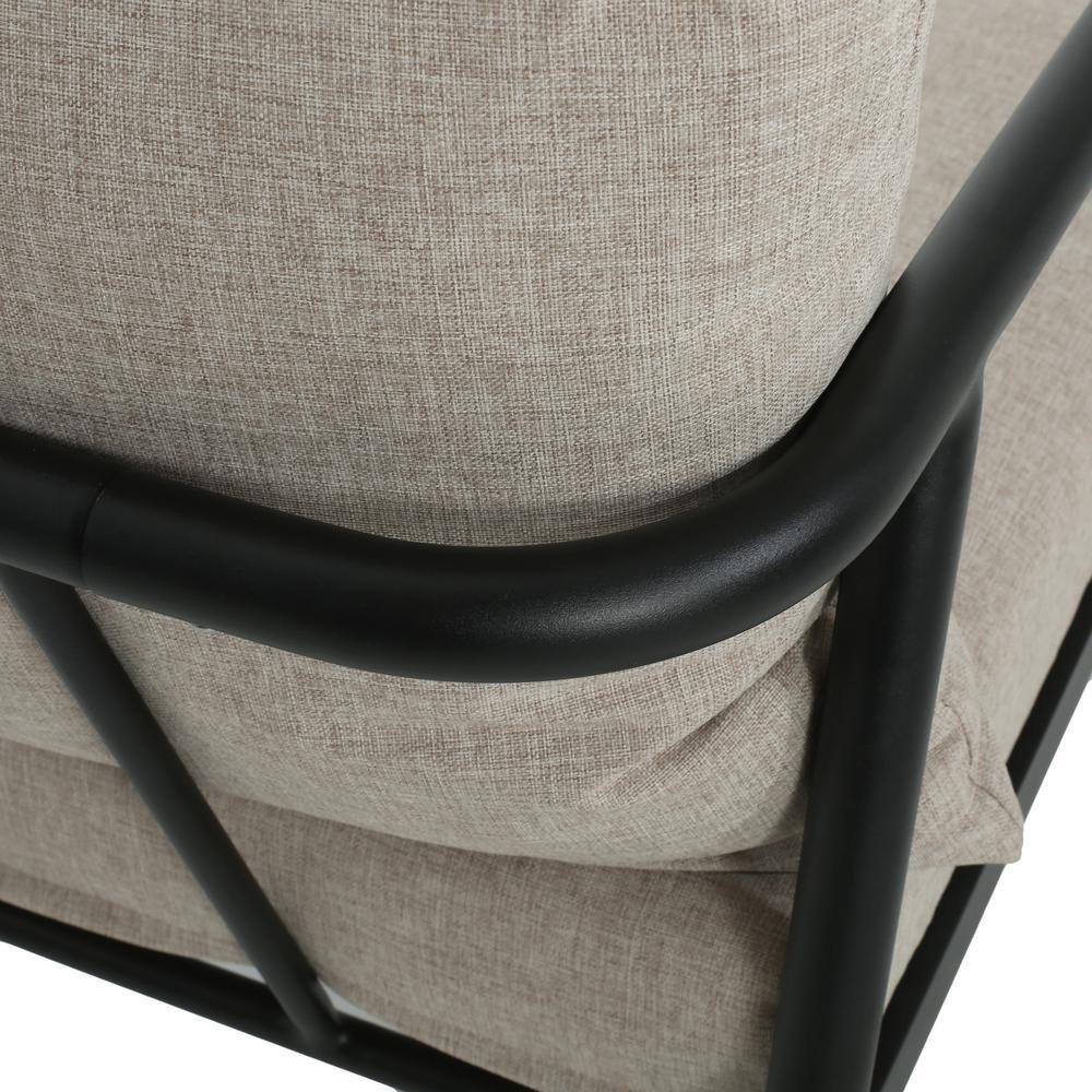 Close-up of the rounded black aluminum armrest and beige cushion of the Noble House club chair.