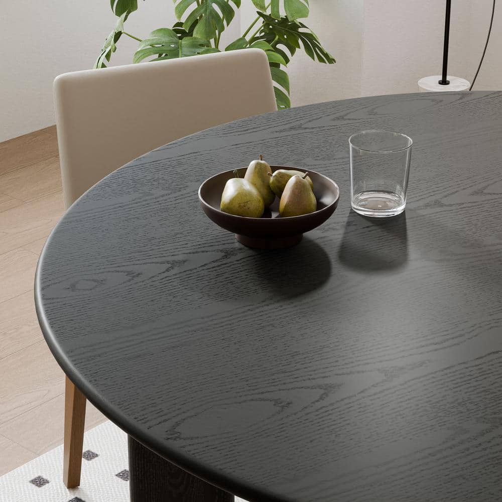 Close-up of a black wood dining table surface showing wood grain.