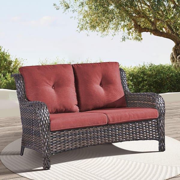 Brown PE Wicker Outdoor Loveseat with Red Cushions and Curved Armrests