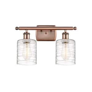 Cobbleskill 16 in. 2-Light Antique Copper Vanity Light with Deco Swirl Glass Shade