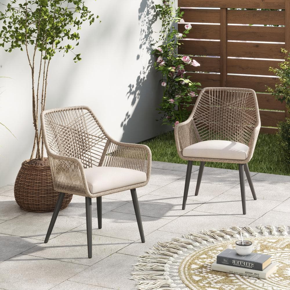Outdoor rattan dining set in a garden setting.