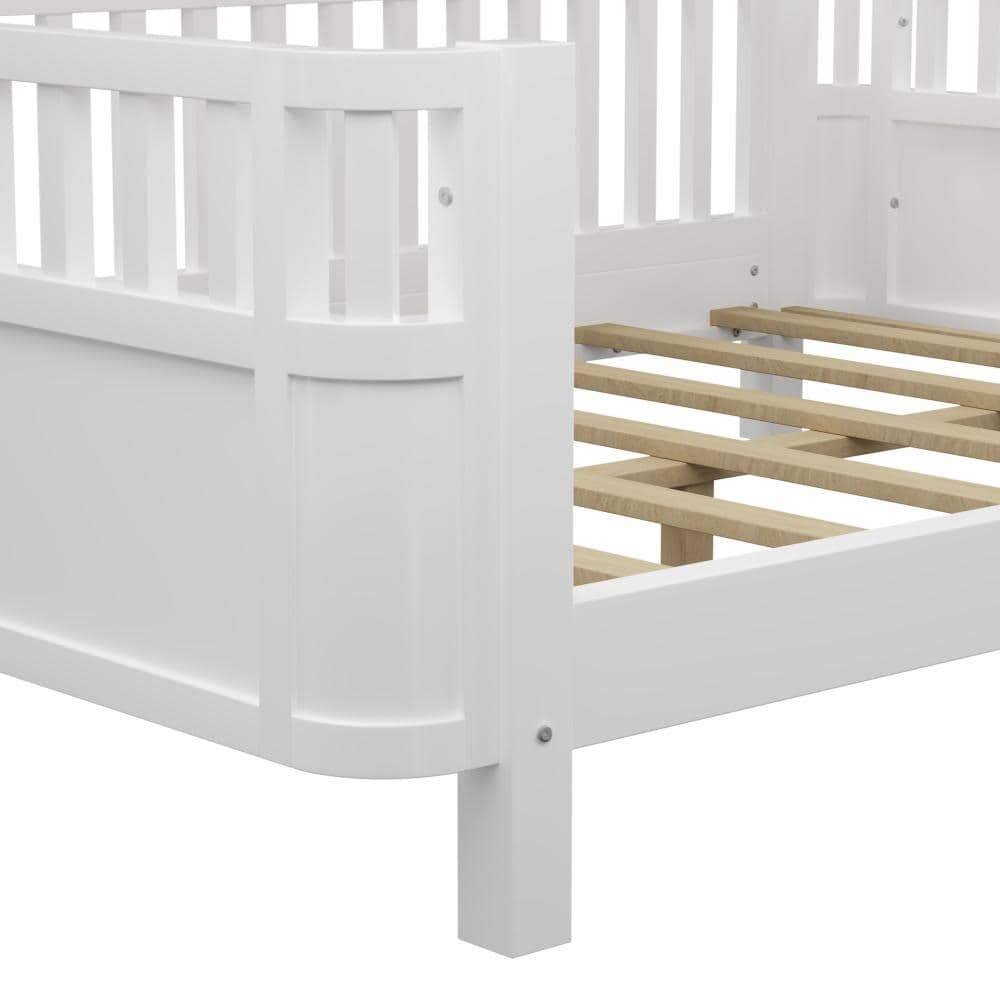 Close-up of the white wood bed frame corner and slats.