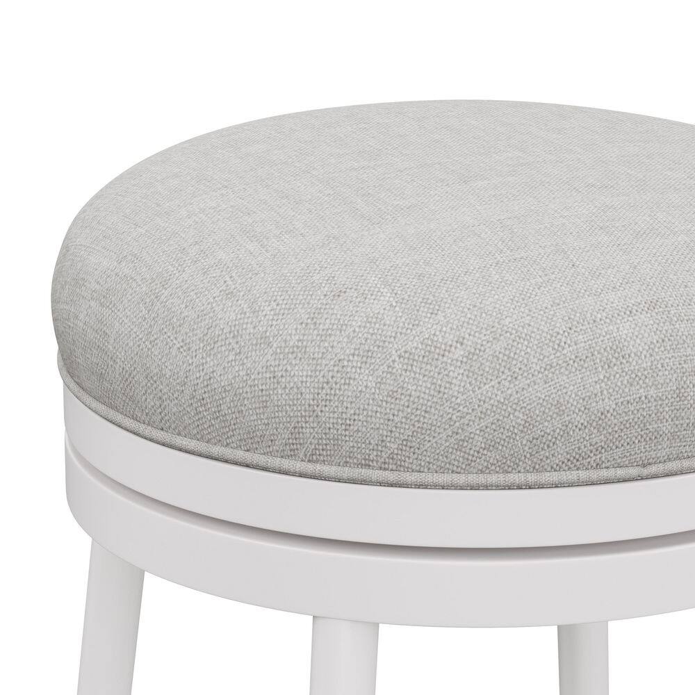 Close-up of the off-white fabric seat of a counter stool.