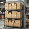Black 4-tier wire shelving unit filled with cardboard boxes in a garage.