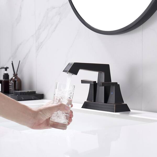 4 in. Centerset Double Handle Low Arc Bathroom Faucet with Drain Kit Included in Oil Rubbed Bronze