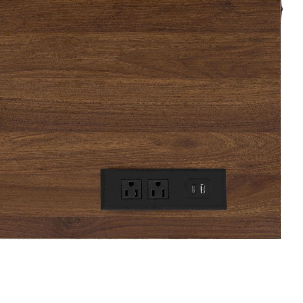 Close-up of the built-in power outlet on the brown tabletop.