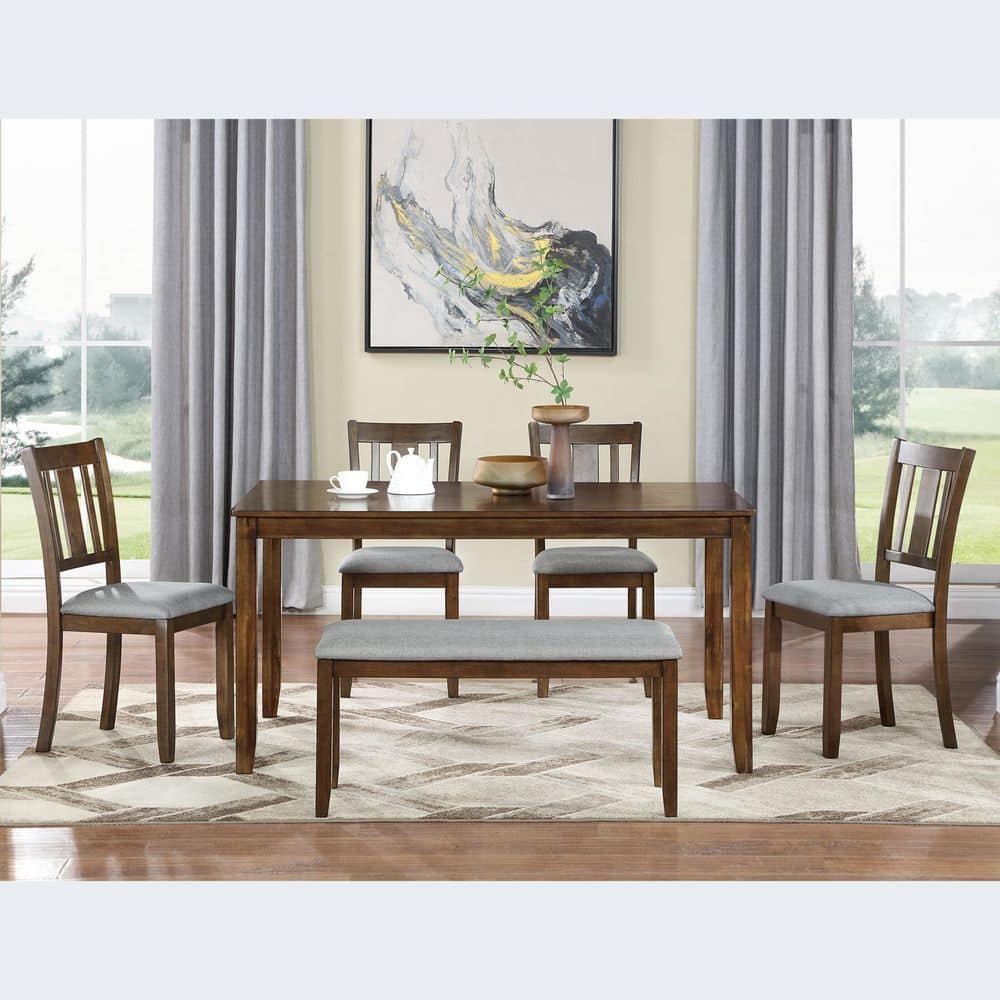 Dining set with wooden table and chairs in a room with curtains.