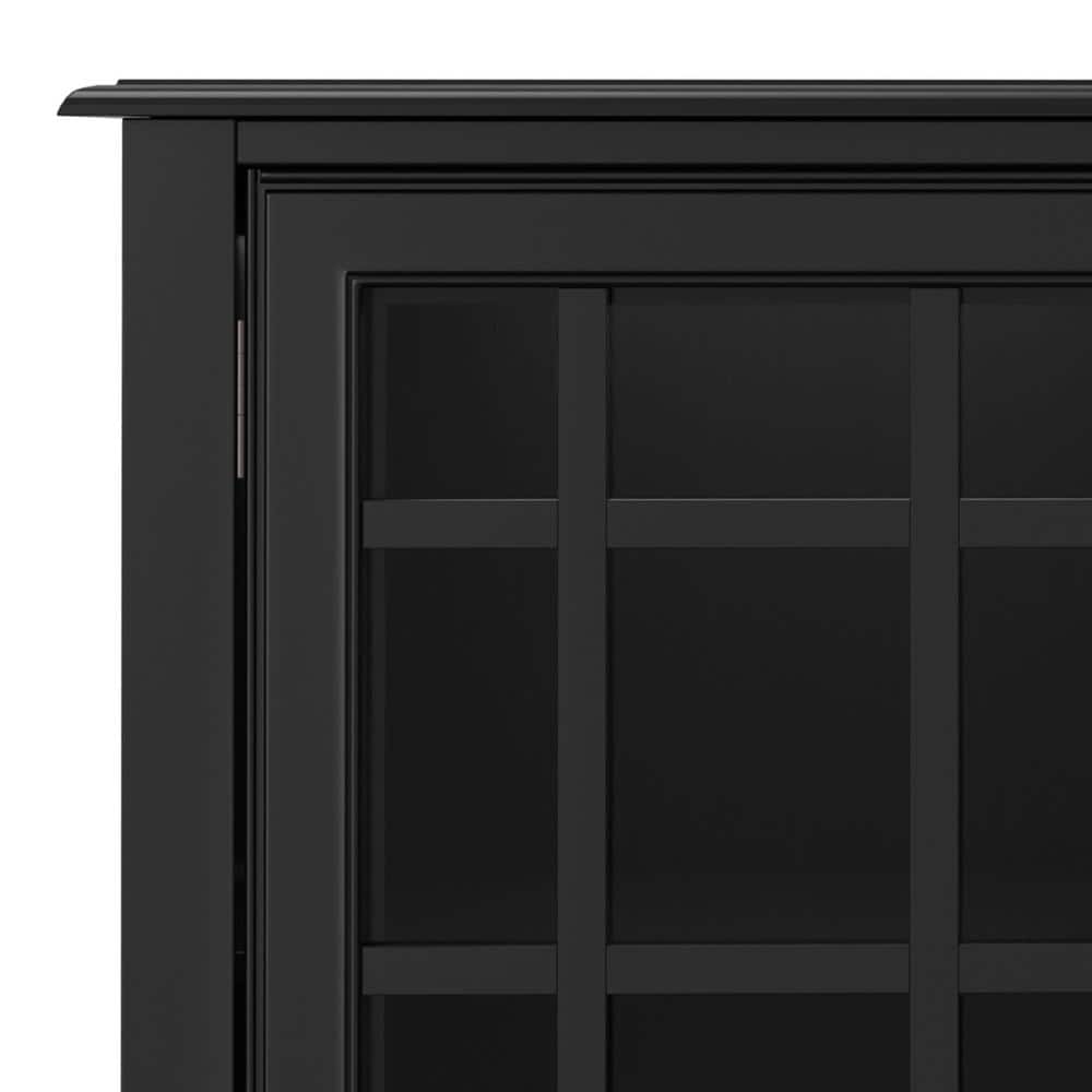 Close-up of the corner and mullioned door of the black storage cabinet.