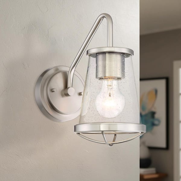 Designers Fountain Darby 5.75 in. 1-Light Satin Platinum Industrial Wall Sconce with Clear Seeded Glass Shade