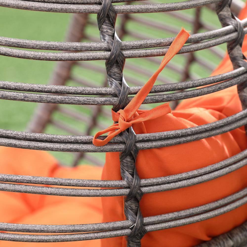Gray Wicker Teardrop Chair with Orange Cushions