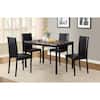 Dining table with black chairs in a room setting.