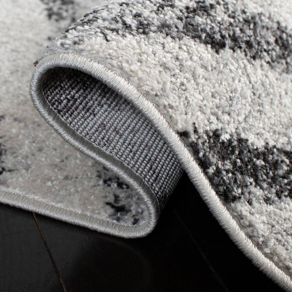 Ivory and Grey Geometric 8' x 10' Synthetic Area Rug